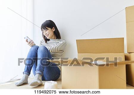 Stock Photography - Young Japanese woman relocating. Fotosearch