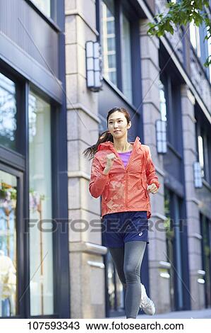 Young Japanese woman running downtown Tokyo View Large Photo Image Stock Image - Young Japanese woman running downtown Tokyo. Fotosearch