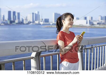 Young Japanese woman running downtown Tokyo View Large Photo Image Stock Image - Young Japanese woman running downtown Tokyo. Fotosearch