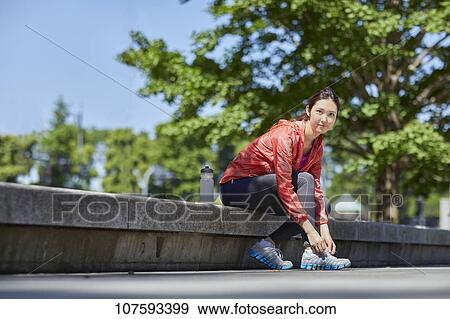 Stock Photo - Young Japanese woman running downtown Tokyo. Fotosearch