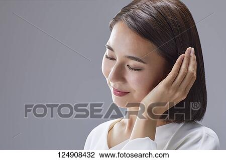 Stock Image - Young Japanese woman studio portrait. Fotosearch