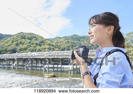 Picture - Young Japanese woman traveling in Kyoto. Fotosearch