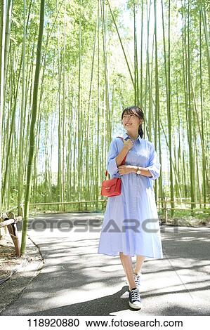 Stock Image - Young Japanese woman traveling in Kyoto. Fotosearch