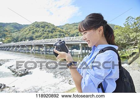 Young Japanese woman traveling in Kyoto View Large Photo Image Stock Image - Young Japanese woman traveling in Kyoto. Fotosearch