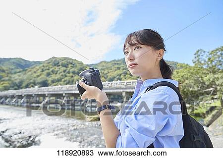 Stock Image - Young Japanese woman traveling in Kyoto. Fotosearch