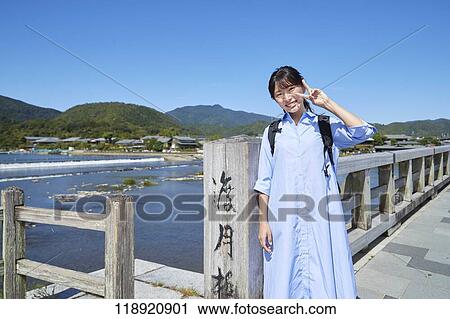 Stock Image - Young Japanese woman traveling in Kyoto. Fotosearch