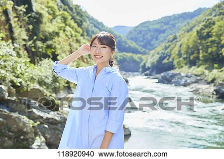 Stock Image - Young Japanese woman traveling in Kyoto. Fotosearch