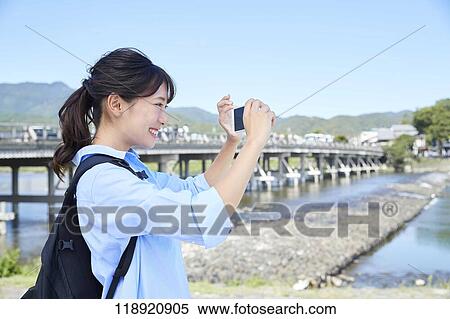 Stock Photography - Young Japanese woman traveling in Kyoto. Fotosearch