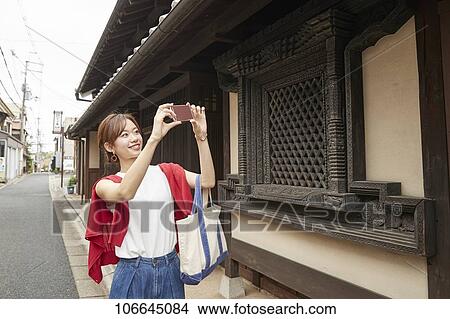 Picture - Young Japanese woman visiting Nara. Fotosearch