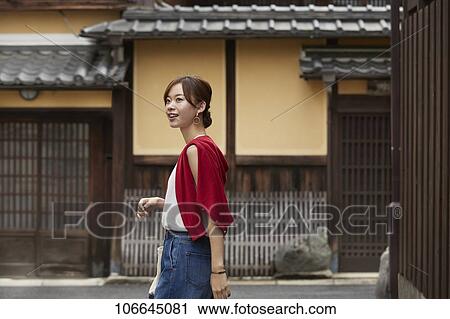 Stock Image - Young Japanese woman visiting Nara. Fotosearch