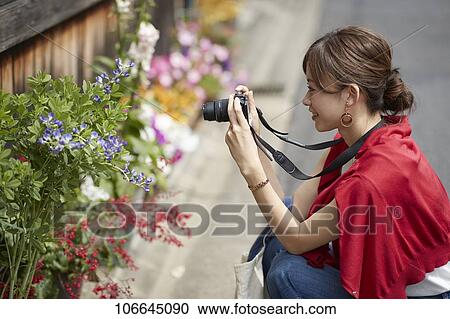 Stock Image - Young Japanese woman visiting Nara. Fotosearch