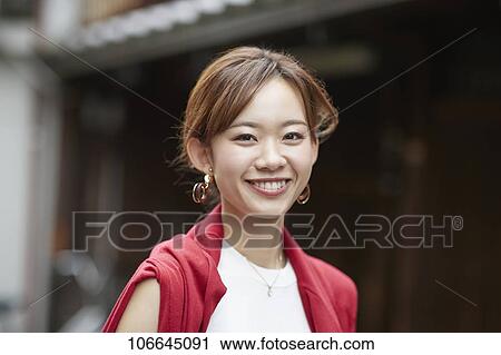 Stock Image - Young Japanese woman visiting Nara. Fotosearch
