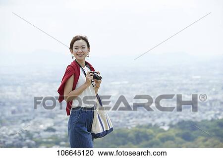 Stock Image - Young Japanese woman visiting Nara. Fotosearch
