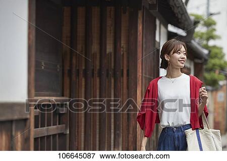 Stock Photo - Young Japanese woman visiting Nara. Fotosearch