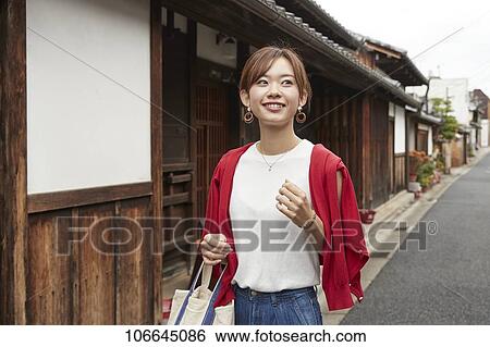 Stock Photograph - Young Japanese woman visiting Nara. Fotosearch