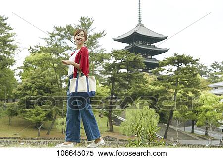Stock Photography - Young Japanese woman visiting Nara. Fotosearch