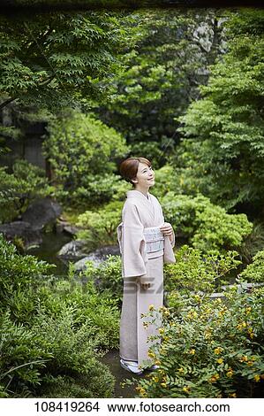 Young Japanese woman wearing traditional kimono View Large Photo Image Picture - Young Japanese woman wearing traditional kimono. Fotosearch