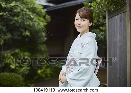 Young Japanese woman wearing traditional kimono View Large Photo Image Stock Image - Young Japanese woman wearing traditional kimono. Fotosearch
