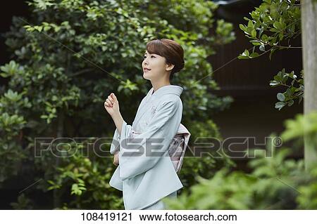 Stock Image - Young Japanese woman wearing traditional kimono. Fotosearch
