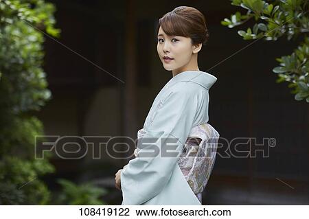 Stock Image - Young Japanese woman wearing traditional kimono. Fotosearch