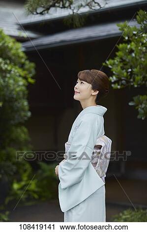 Stock Image - Young Japanese woman wearing traditional kimono. Fotosearch