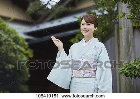Young Japanese woman wearing traditional kimono View Large Photo Image Stock Image - Young Japanese woman wearing traditional kimono. Fotosearch