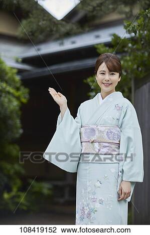 Young Japanese woman wearing traditional kimono View Large Photo Image Stock Image - Young Japanese woman wearing traditional kimono. Fotosearch