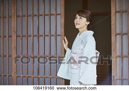 Young Japanese woman wearing traditional kimono View Large Photo Image Stock Image - Young Japanese woman wearing traditional kimono. Fotosearch