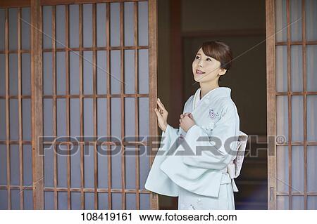 Stock Image - Young Japanese woman wearing traditional kimono. Fotosearch