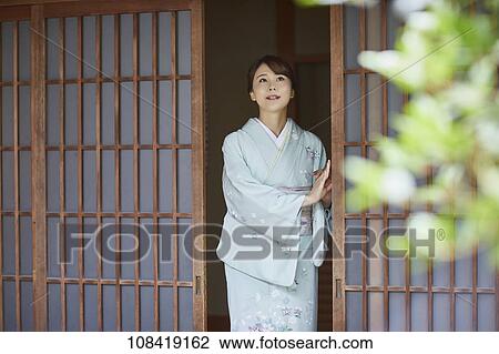 Stock Image - Young Japanese woman wearing traditional kimono. Fotosearch