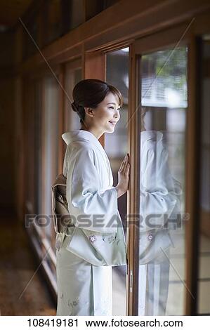Young Japanese woman wearing traditional kimono View Large Photo Image Stock Image - Young Japanese woman wearing traditional kimono. Fotosearch