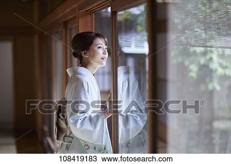 Stock Image - Young Japanese woman wearing traditional kimono. Fotosearch