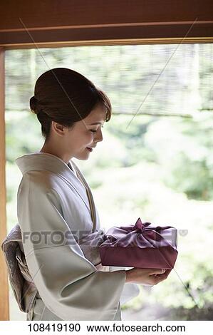 Young Japanese woman wearing traditional kimono View Large Photo Image Stock Image - Young Japanese woman wearing traditional kimono. Fotosearch