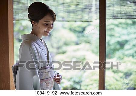 Young Japanese woman wearing traditional kimono View Large Photo Image Stock Image - Young Japanese woman wearing traditional kimono. Fotosearch