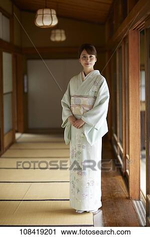 Stock Image - Young Japanese woman wearing traditional kimono. Fotosearch