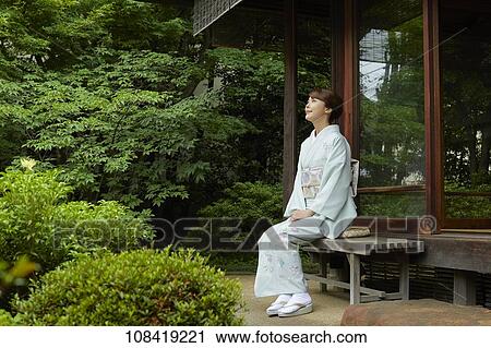 Stock Image - Young Japanese woman wearing traditional kimono. Fotosearch