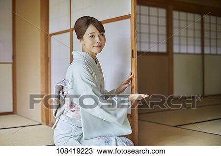 Stock Image - Young Japanese woman wearing traditional kimono. Fotosearch