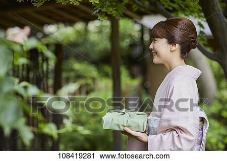 Young Japanese woman wearing traditional kimono View Large Photo Image Stock Image - Young Japanese woman wearing traditional kimono. Fotosearch