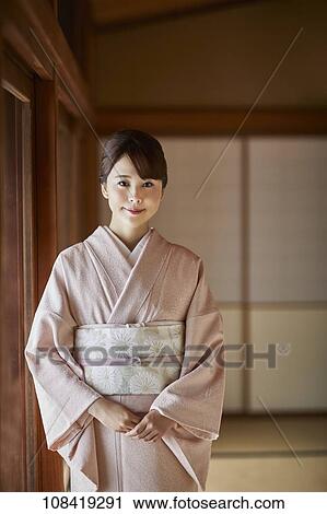Young Japanese woman wearing traditional kimono View Large Photo Image Stock Image - Young Japanese woman wearing traditional kimono. Fotosearch