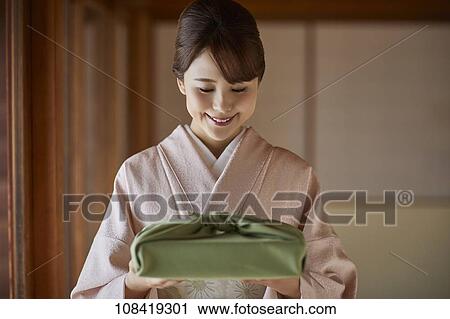 Young Japanese woman wearing traditional kimono View Large Photo Image Stock Image - Young Japanese woman wearing traditional kimono. Fotosearch