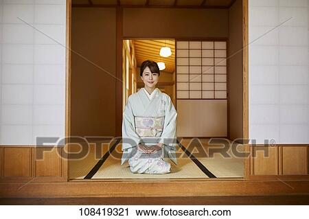 Stock Image - Young Japanese woman wearing traditional kimono. Fotosearch