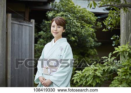 Stock Image - Young Japanese woman wearing traditional kimono. Fotosearch