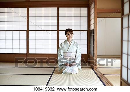 Stock Image - Young Japanese woman wearing traditional kimono. Fotosearch