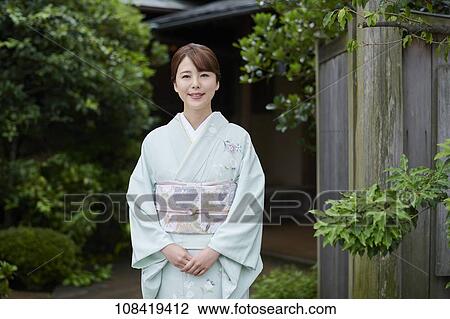Stock Image - Young Japanese woman wearing traditional kimono. Fotosearch