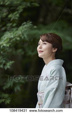 Stock Image - Young Japanese woman wearing traditional kimono. Fotosearch