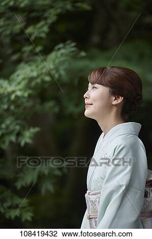 Stock Image - Young Japanese woman wearing traditional kimono. Fotosearch