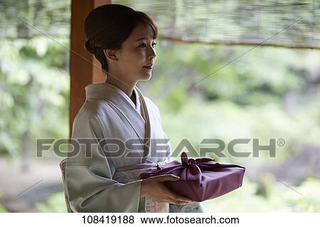 Young Japanese woman wearing traditional kimono View Large Photo Image Stock Photo - Young Japanese woman wearing traditional kimono. Fotosearch