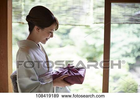 Young Japanese woman wearing traditional kimono View Large Photo Image Stock Photo - Young Japanese woman wearing traditional kimono. Fotosearch