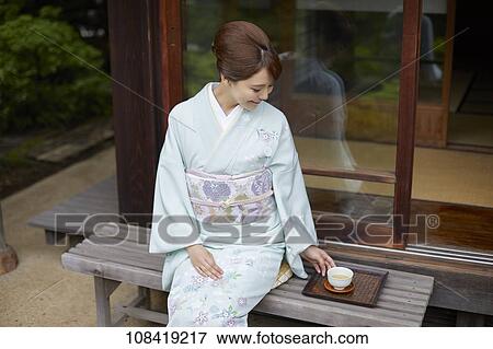 Stock Photo - Young Japanese woman wearing traditional kimono. Fotosearch