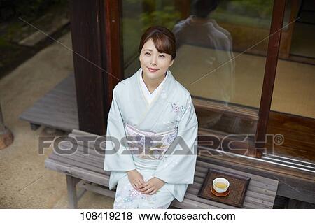 Young Japanese woman wearing traditional kimono View Large Photo Image Stock Photo - Young Japanese woman wearing traditional kimono. Fotosearch